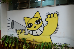 Wall art by artist M. Chat, a cat with a horn.